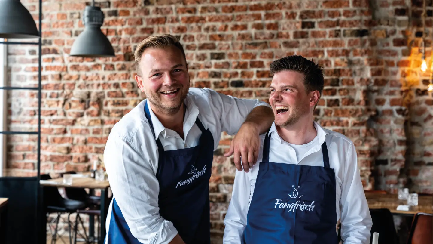 Constantin & Tristan stehen in ihrem Fischrestaurant in Lübeck